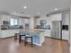 Spacious kitchen with white cabinetry, stainless appliances, and a central island with bar stools at 12249 Catanzaro Ave, Las Vegas, NV 89138