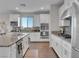 Modern kitchen with white cabinets, granite countertops, and stainless steel appliances at 12249 Catanzaro Ave, Las Vegas, NV 89138