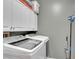 Modern laundry room with white cabinets and updated washer and dryer at 12249 Catanzaro Ave, Las Vegas, NV 89138