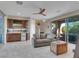 Entertaining space featuring bar area, leather couch, and glass doors to the patio at 12249 Catanzaro Ave, Las Vegas, NV 89138