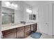 Main bathroom with double vanity, walk-in shower, and granite countertops at 12249 Catanzaro Ave, Las Vegas, NV 89138