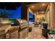 Outdoor kitchen with stainless steel grill and bar, overlooking the pool and patio area at 12249 Catanzaro Ave, Las Vegas, NV 89138
