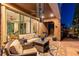 Cozy covered patio with comfortable seating, ceiling fan, and access to the backyard at 12249 Catanzaro Ave, Las Vegas, NV 89138
