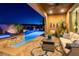 Relaxing outdoor patio area with a seating arrangement, featuring pool views at 12249 Catanzaro Ave, Las Vegas, NV 89138