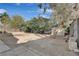 Spacious backyard featuring gravel, a shed for storage, mature trees, and ample room for customization at 1225 S 15Th St, Las Vegas, NV 89104