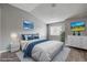 Bedroom with plush bedding, modern furniture, and scenic art pieces at 1660 Cloister Ave, Henderson, NV 89014