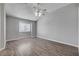 Spacious bedroom with hardwood floors, ceiling fan, and a large window at 1660 Cloister Ave, Henderson, NV 89014