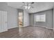 Bedroom featuring hardwood floors, a ceiling fan, and access to the ensuite bathroom at 1660 Cloister Ave, Henderson, NV 89014