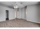 Open bedroom with hardwood floors, two entry doors, and a ceiling fan at 1660 Cloister Ave, Henderson, NV 89014