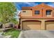 Two-story home showcasing a two-car garage, red tile roof, and well-maintained lawn with a tree at 1660 Cloister Ave, Henderson, NV 89014