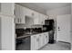 Kitchen boasts white cabinetry and dark countertops, stainless steel appliances at 1660 Cloister Ave, Henderson, NV 89014