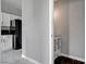 Bright kitchen with white cabinets, black refrigerator and modern marble floors at 1660 Cloister Ave, Henderson, NV 89014