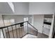 Open-concept living space with hardwood floors, fireplace, and staircase access at 1660 Cloister Ave, Henderson, NV 89014