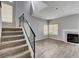 Bright living room features a staircase, fireplace, and large windows at 1660 Cloister Ave, Henderson, NV 89014