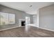 Spacious living area with fireplace, wood floors, and sliding door to patio at 1660 Cloister Ave, Henderson, NV 89014