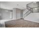 Open living area with staircase, wood floors, and modern design at 1660 Cloister Ave, Henderson, NV 89014