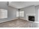 Bright living room with a fireplace and natural light from large windows at 1660 Cloister Ave, Henderson, NV 89014