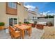 Backyard patio featuring an outdoor table, lounge chairs and a beautiful garden at 1660 Cloister Ave, Henderson, NV 89014