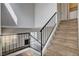 Carpeted staircase with black metal railing, leading to the upper level at 1660 Cloister Ave, Henderson, NV 89014