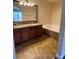 Bathroom featuring double sinks, granite counters, wood cabinets and a soaking tub at 1858 N Decatur Blvd # 204, Las Vegas, NV 89108
