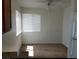 This bedroom area has light brown carpet, a ceiling fan with lighting, and natural light coming in through the windows at 1858 N Decatur Blvd # 204, Las Vegas, NV 89108