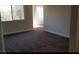 This bedroom is spacious, featuring neutral-colored carpet and paint with natural lighting from the window at 1858 N Decatur Blvd # 204, Las Vegas, NV 89108