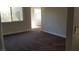 This bedroom is spacious, featuring neutral-colored carpet and paint with natural lighting from the window at 1858 N Decatur Blvd # 204, Las Vegas, NV 89108