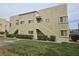 Apartment building with stairs leading to upper units and manicured bushes at 1858 N Decatur Blvd # 204, Las Vegas, NV 89108