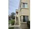 Exterior view of a condo featuring a private entrance with stairs, lush greenery, and a welcoming atmosphere at 1858 N Decatur Blvd # 204, Las Vegas, NV 89108
