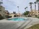 Community pool surrounded by meticulously maintained landscaping, tall palm trees, and inviting lounge areas at 1858 N Decatur Blvd # 204, Las Vegas, NV 89108