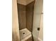 Shower stall featuring granite-like tiled walls and a partial glass door at 1858 N Decatur Blvd # 204, Las Vegas, NV 89108