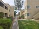 Picturesque walkway through complex, complemented by verdant landscaping, creating a serene living environment at 1858 N Decatur Blvd # 204, Las Vegas, NV 89108