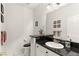 This powder bathroom includes modern fixtures and a classic sink and toilet at 2037 Summer Blossom Ct # 101, Las Vegas, NV 89134