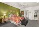 Comfortable bedroom featuring patterned bedding, a ceiling fan, and green accent wall at 2037 Summer Blossom Ct # 101, Las Vegas, NV 89134