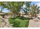 Beautiful single-story home with lush landscaping and mature trees creating a serene and inviting outdoor space at 2037 Summer Blossom Ct # 101, Las Vegas, NV 89134