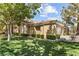 Inviting single-story home featuring a well-manicured lawn, mature trees, and a cozy, neighborhood feel at 2037 Summer Blossom Ct # 101, Las Vegas, NV 89134