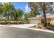 Well-maintained single-story home with a spacious driveway and attached garage, framed by mature trees at 2037 Summer Blossom Ct # 101, Las Vegas, NV 89134