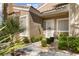 Charming front entrance features a well-maintained garden and a welcoming white front door at 2037 Summer Blossom Ct # 101, Las Vegas, NV 89134