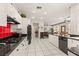 The kitchen features white cabinets, black countertops, and modern appliances with an adjacent living area at 2037 Summer Blossom Ct # 101, Las Vegas, NV 89134