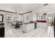 Bright eat-in kitchen features white cabinets, an island with bar seating and lots of natural light at 2037 Summer Blossom Ct # 101, Las Vegas, NV 89134