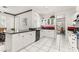 Bright kitchen features white cabinets, black countertops, and tile flooring at 2037 Summer Blossom Ct # 101, Las Vegas, NV 89134