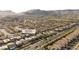 Extensive aerial perspective highlighting the property at 235 Desert Arroyo Ct. in a residential area, mountains in the background at 235 Desert Arroyo Ct, Henderson, NV 89012