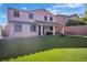 Expansive backyard boasting an artificial lawn, covered patio with seating, and a cozy fire pit area at 235 Desert Arroyo Ct, Henderson, NV 89012