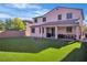 Spacious backyard featuring a well-maintained lawn, covered patio, and ample space for outdoor activities at 235 Desert Arroyo Ct, Henderson, NV 89012