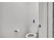Minimalist bathroom featuring a white toilet and neutral-toned walls, offering a clean aesthetic at 235 Desert Arroyo Ct, Henderson, NV 89012