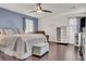 A primary bedroom features a king bed, wood floors, and a large ceiling fan at 235 Desert Arroyo Ct, Henderson, NV 89012