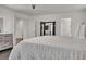 A primary bedroom features a king bed, mirrored closet doors, wood floors, and neutral decor at 235 Desert Arroyo Ct, Henderson, NV 89012