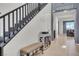 Elegant foyer with staircase, bench, and tile flooring leading into living area at 235 Desert Arroyo Ct, Henderson, NV 89012