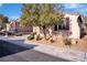 A well-maintained front yard with desert landscaping and mature shade trees at 235 Desert Arroyo Ct, Henderson, NV 89012