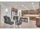 Open-concept kitchen with stainless steel appliances, spacious island, and dining area at 235 Desert Arroyo Ct, Henderson, NV 89012